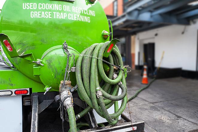 grease trap being pumped out by service technician in Palmerton
